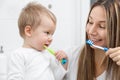 Happy mother teaching her son how to bush teeth Royalty Free Stock Photo