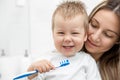 Happy mother teaching her son how to bush teeth Royalty Free Stock Photo