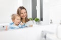 Happy mother teaching her son how to bush teeth Royalty Free Stock Photo