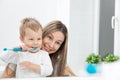 Happy mother teaching her son how to bush teeth Royalty Free Stock Photo