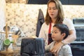 happy Mother teaching son making breakfast toast bread with toaster at home kitchen together . loving family.  child boy excited Royalty Free Stock Photo