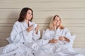 Happy mother and teenage daughter drinking coffee and talking Royalty Free Stock Photo