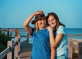 Happy Mother and teenage daughter on pier embracing and smiling Royalty Free Stock Photo