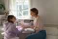 Happy mother and teenage daughter studying together, having fun Royalty Free Stock Photo