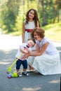 Happy Mother with teenage daughter and Toddler son for a walk in park Royalty Free Stock Photo