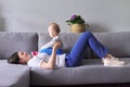 Happy mother with toddler son at home. Laughing woman playing with baby Royalty Free Stock Photo