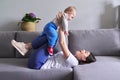 Happy mother with toddler son at home. Laughing woman playing with baby Royalty Free Stock Photo