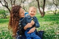 Happy mother and toddler son playing outdoor in spring or summer park Royalty Free Stock Photo