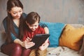 happy mother and toddler son using tablet at home. Family playing computer or searching internet Royalty Free Stock Photo