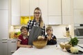 Happy mother and two kids preparing dough Royalty Free Stock Photo