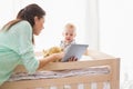 Happy mother using tablet with his baby boy Royalty Free Stock Photo