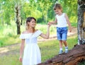 Happy mother walking with child son together outdoors in summer Royalty Free Stock Photo