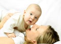 Happy mother on the white sofa with her baby Royalty Free Stock Photo