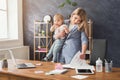 Young mother talking on phone and spending time with baby