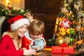 Happy mother is writing a letter to Santa with her lovely son. Happy Christmas family. New Year time. Royalty Free Stock Photo