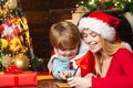 Happy mother is writing a letter to Santa with her lovely son. Happy Christmas family. New Year time. Royalty Free Stock Photo