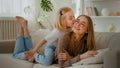 Happy motherhood family bonding affectionate love Caucasian mother lying on couch sofa daughter little girl child Royalty Free Stock Photo