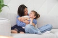 Happy motherhood, unconditional love, beautiful mother and little daughter portrait concept. Lovely kid girl hangs on mom neck Royalty Free Stock Photo