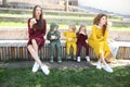 Happy mothers with children in fashionable clothes family look in a park Royalty Free Stock Photo