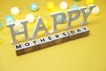 Happy Mothers Day alphabet letter with LED cotton balls on yellow background Royalty Free Stock Photo