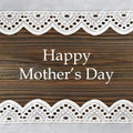 Happy Mothers Day card with lace borders on wooden background