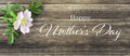 Happy Mothers Day card with wild rose on wooden background Royalty Free Stock Photo