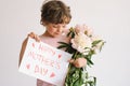 Happy Mothers Day. Cheerful happy child with Peonys bouquet.