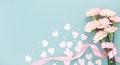 Happy mothers day composition. Pink carnation flowers and paper hearts on pastel blue background top view Royalty Free Stock Photo