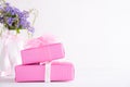 Happy mothers day concept. Gift box with purple flower on white wooden table background
