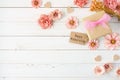 Happy Mothers Day corner border with paper flowers, gift box and tag over a white wood background Royalty Free Stock Photo