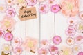 Happy Mothers Day gift tag with frame of pink paper flowers over a white wood background Royalty Free Stock Photo