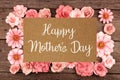 Happy Mothers Day greeting card with frame of pink paper flowers over wood Royalty Free Stock Photo