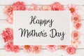 Happy Mothers Day greeting card with frame of pink paper flowers over white wood Royalty Free Stock Photo