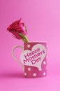 Happy Mothers Day heart gift tag on pink polka dot coffee mug Royalty Free Stock Photo