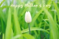 Happy Mothers Day. Holiday card with greeting text. White tulip flower in light green fresh grass. Artistic amazing spring nature Royalty Free Stock Photo