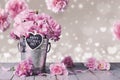 Happy mothers day letter on wood heart and pink carnation flower