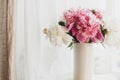 Happy Mothers day. Lovely peony bouquet in sunny light on rustic wooden window sill. Stylish pink and white peonies in vase on