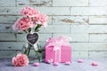 Happy mothers day message on heart wood and pink carnation flower in clear bottle and gift box Royalty Free Stock Photo