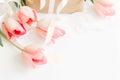 Happy Mothers day.  Pink tulips with ribbon and gift box on white background, space for text. Stylish soft image of spring flowers Royalty Free Stock Photo