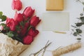 Happy Mothers day. Red tulips with greeting card, gift, pencil, scissors on rustic wood flat lay Royalty Free Stock Photo