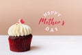 Happy Mothers Day, sweet red heart on white cream cupcake