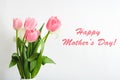 Happy Mothers Day text on gift card in flower bouquet on white background. Greeting card for Mom. Flower delivery, Congratulations Royalty Free Stock Photo