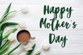 Happy mothers day text sign on tulips and coffee on white wooden Royalty Free Stock Photo