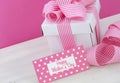 Happy Mothers Day white gift box with pink stripe ribbon. Royalty Free Stock Photo