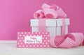 Happy Mothers Day white gift box with pink stripe ribbon. Royalty Free Stock Photo