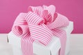 Happy Mothers Day white gift box with pink stripe ribbon. Royalty Free Stock Photo