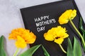 Happy Mothers Day words and yellow tulips