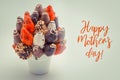 Happy Mothers greeting card with red lettering; A bundle of edible flowers, arrangement of strawberries covered with chocolate