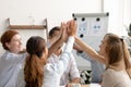 Happy motivated business team giving high five after successful teamwork