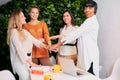 Happy motivated female multi-ethnic team joined hands at meeting Royalty Free Stock Photo